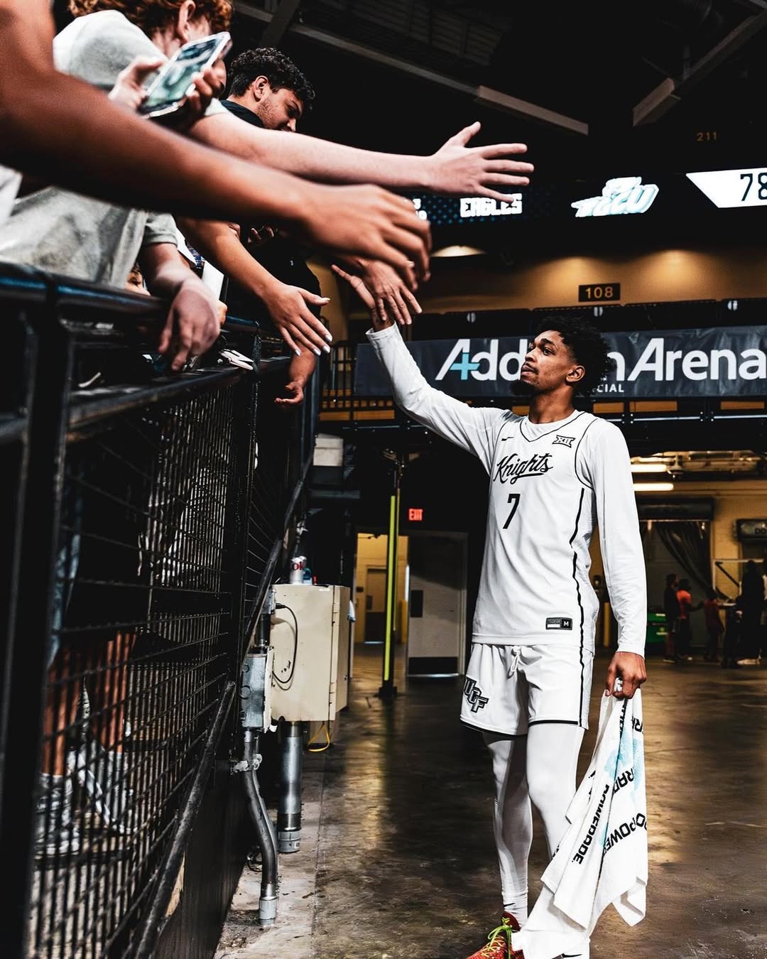 Dior Johnson greeting fans in UCF gear before a game